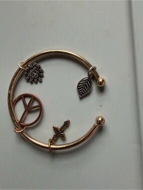 Gold-tone Charm Bangle Bracelet with Peace, Cross & Leaf Charms